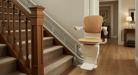 Standing and perching stairlifts suit narrow stairs: a compact stairlift parked at the foot of a staircase